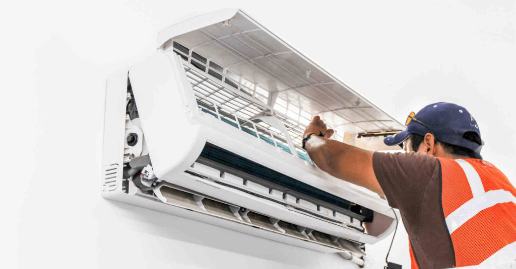 air-conditioning-contractor-at-work-on-a-air-con-compressor